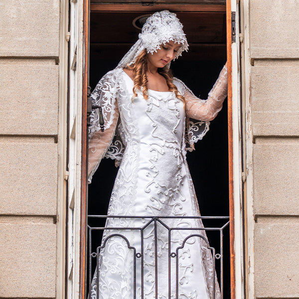 Padme in a wedding dress standing in the window